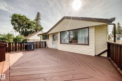 Expansive wood-finish deck with geometric plank pattern, perimeter railing, and direct exterior access - 