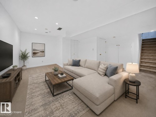 Recessed ceiling lighting, light-toned carpeting, white walls, and built-in closet doors - #47 30 Levasseur Rd, St. Albert, AB - Indoor Photo Showing Living Room
