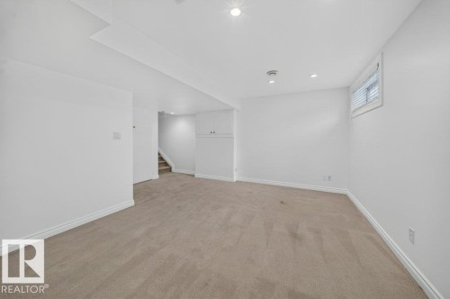 Recessed ceiling lighting, built-in storage cabinetry, a single window, and neutral carpeting - #47 30 Levasseur Rd, St. Albert, AB - Indoor Photo Showing Other Room