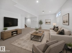 Recessed lighting illuminates this carpeted living space with a wood-finish media console - 