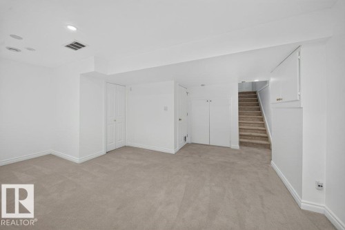 Recessed ceiling lighting, wall-to-wall carpeting, built-in cabinetry, and white interior doors - #47 30 Levasseur Rd, St. Albert, AB - Indoor Photo Showing Other Room