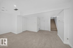 Recessed ceiling lighting, wall-to-wall carpeting, built-in cabinetry, and white interior doors - 