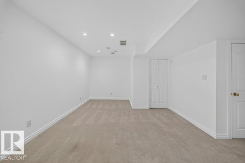 Recessed lighting illuminating a neutral carpeted floor and white walls - #47 30 Levasseur Rd, St. Albert, AB - Indoor Photo Showing Other Room