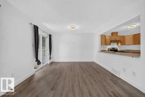 Wood-finish flooring, white walls, and contemporary overhead lighting - #47 30 Levasseur Rd, St. Albert, AB - Indoor Photo Showing Kitchen
