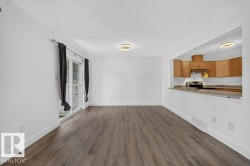 Wood-finish flooring, white walls, and contemporary overhead lighting - 