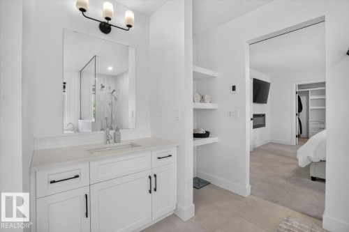 White shaker-style vanity with a light-toned countertop and undermount sink - 94 Harvest Crescent, Ardrossan, AB - Indoor Photo Showing Bathroom