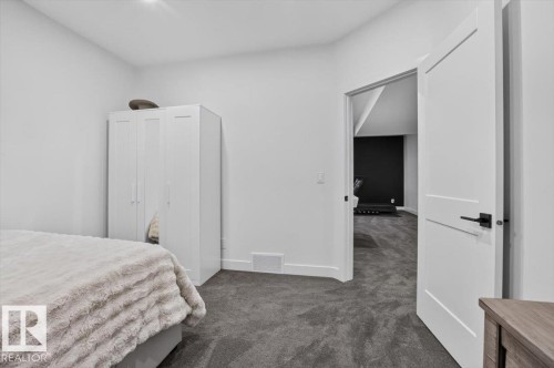 Neutral wall color with dark carpeting - 94 Harvest Crescent, Ardrossan, AB - Indoor Photo Showing Bedroom