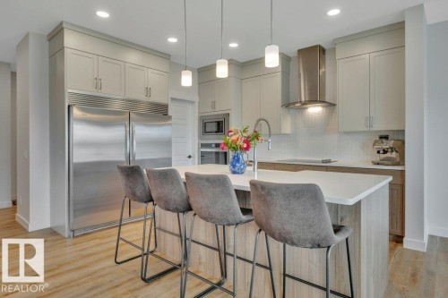 With stainless steel appliances (including side-by-side fridge/freezer) - 5329 Lark Landing Nw, Edmonton, AB - Indoor Photo Showing Kitchen With Upgraded Kitchen