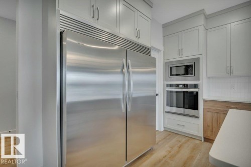 With side-by-side fridge/freezer combo - 5329 Lark Landing Nw, Edmonton, AB - Indoor Photo Showing Kitchen