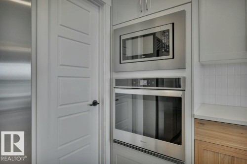 Corner pantry and built in wall oven and microwave - 5329 Lark Landing Nw, Edmonton, AB - Indoor Photo Showing Kitchen