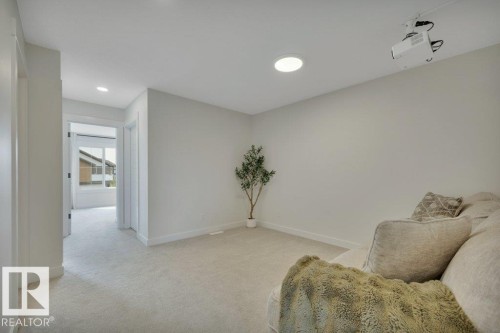 With projector - 5329 Lark Landing Nw, Edmonton, AB - Indoor Photo Showing Other Room