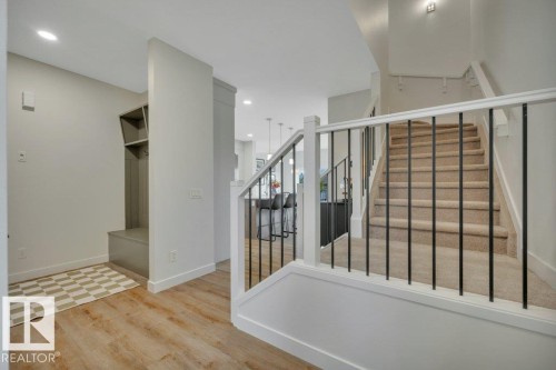 Metal spindle railings leading to 2nd floor - 5329 Lark Landing Nw, Edmonton, AB - Indoor Photo Showing Other Room