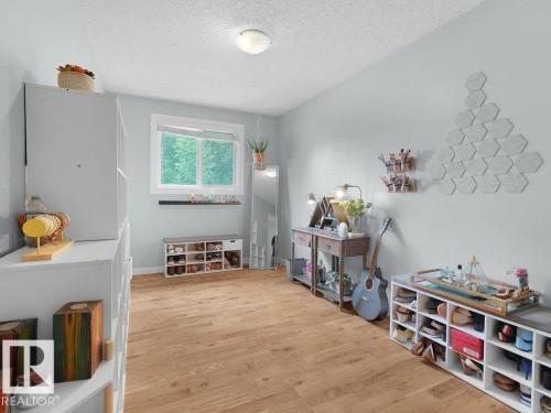 Wood-finish flooring, white trim window, and ceiling-mounted light fixture - #54 2131 Oak St, Sherwood Park, AB - Indoor