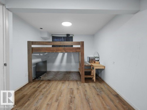 Wood-finish flooring with white walls and a ceiling-mounted light fixture - #54 2131 Oak St, Sherwood Park, AB - Indoor