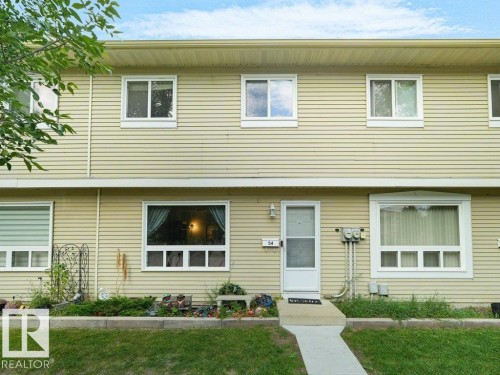 Two-story exterior with horizontal siding and a light-colored main entry door - #54 2131 Oak St, Sherwood Park, AB - Outdoor