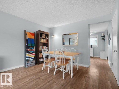 Wood-finish flooring throughout, light-colored wall paint, white trim, and a recessed doorway - #54 2131 Oak St, Sherwood Park, AB - Indoor Photo Showing Dining Room