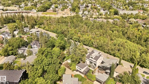 Aerial perspective showcasing a residential neighborhood with abundant mature trees and varied architectural styles - 14631 Summit Drive Nw, Edmonton, AB 
