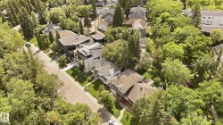 Expansive neighborhood featuring mature trees and established residential properties - 