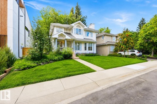 Two-story residence with a gabled roofline, front porch with columns, and light-colored siding - 14631 Summit Drive Nw, Edmonton, AB 