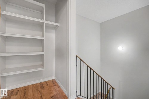Built-in white shelving unit with wood-finish flooring - 1096 Knottwood Road Nw, Edmonton, AB - Indoor