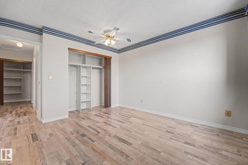 Light wood-finish flooring throughout - 1096 Knottwood Road Nw, Edmonton, AB - Indoor Photo Showing Other Room