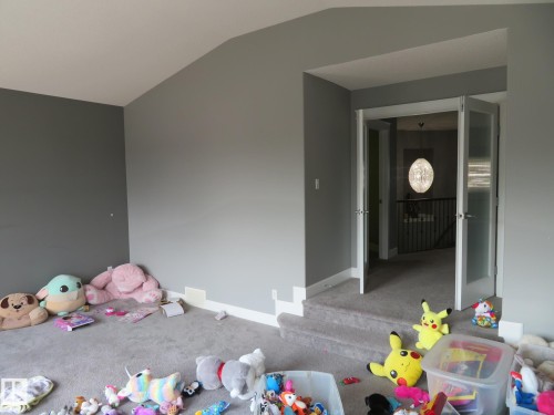Carpeted flooring, vaulted ceiling, and double French doors with frosted glass panels - 3233 Winspear Crescent Sw, Edmonton, AB - Indoor Photo Showing Bedroom
