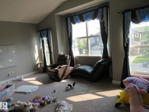 Carpeted room with vaulted ceiling and multiple windows - 3233 Winspear Crescent Sw, Edmonton, AB - Indoor