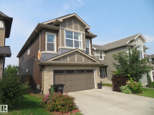 Multi-story residence featuring a gabled roofline, stone facade accents, and a two-car garage - 3233 Winspear Crescent Sw, Edmonton, AB - Outdoor
