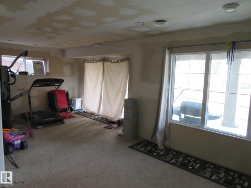 Carpeted flooring throughout, recessed ceiling lighting, and large windows providing natural light - 3233 Winspear Crescent Sw, Edmonton, AB - Indoor