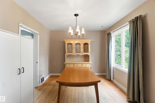 Hardwood flooring, painted walls, and a multi-pane window - 11710 94 Street Nw, Edmonton, AB - Indoor Photo Showing Other Room