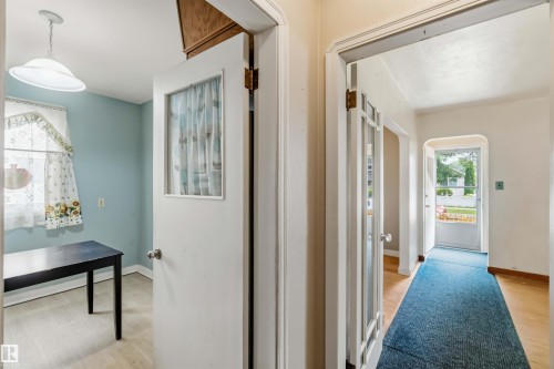 Interior doorway with glass paneling and an overhead light fixture - 11710 94 Street Nw, Edmonton, AB - Indoor Photo Showing Other Room