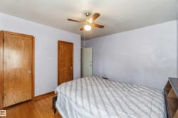 Hardwood flooring, wood doors, ceiling fan with integrated lighting, and painted walls - 