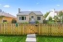 Stucco exterior, gabled roofline, front entry steps, front door with sidelight, and a wood privacy fence - 11710 94 Street Nw, Edmonton, AB  - Outdoor 