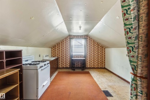 Room with sloped ceilings, a window, and a built-in sink with a countertop - 11710 94 Street Nw, Edmonton, AB - Indoor