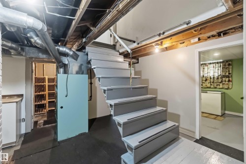 Painted wooden staircase - 11710 94 Street Nw, Edmonton, AB - Indoor Photo Showing Basement