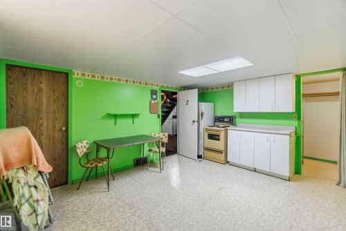 Vinyl flooring, built-in cabinetry, overhead lighting, and wood-finish doors - 11710 94 Street Nw, Edmonton, AB - Indoor