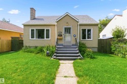 Stucco exterior residence with a gabled roofline and an exterior chimney - 