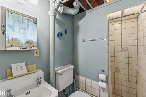 White pedestal sink with chrome faucets - 11710 94 Street Nw, Edmonton, AB - Indoor Photo Showing Bathroom