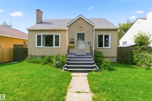 Stucco exterior residence with a gabled roofline and an exterior chimney - 11710 94 Street Nw, Edmonton, AB - Outdoor