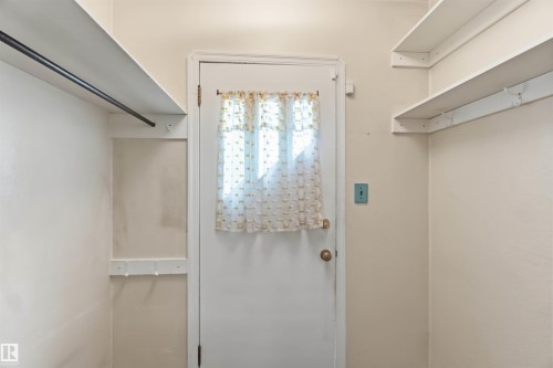 Entryway featuring a white door, overhead lighting, and built-in shelving - 11710 94 Street Nw, Edmonton, AB - Indoor