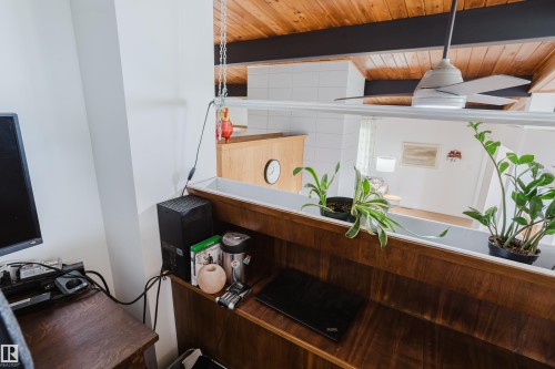 Wood-finish ceiling with exposed beams and a ceiling fan - 9059 52 Street Nw, Edmonton, AB - Indoor Photo Showing Other Room