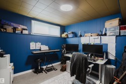Room featuring paneling, a drop ceiling, and an upper window - 