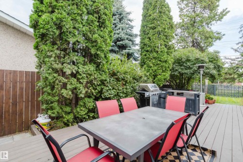 Deck featuring composite decking, privacy fencing, and mature landscaping - 9059 52 Street Nw, Edmonton, AB - Outdoor With Deck Patio Veranda