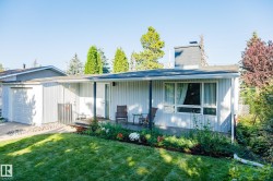 Modern single-story residence featuring corrugated metal siding, a covered front porch with large windows, and an attached garage - 