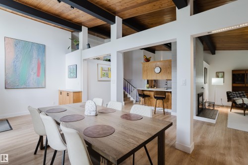 Vaulted wood-paneled ceiling with exposed beams, wood-finish flooring, built-in fireplace, and wood cabinetry - 9059 52 Street Nw, Edmonton, AB - Indoor Photo Showing Dining Room