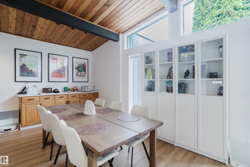 Wood-finish flooring with a vaulted wood plank ceiling and exposed beam - 9059 52 Street Nw, Edmonton, AB - Indoor Photo Showing Dining Room