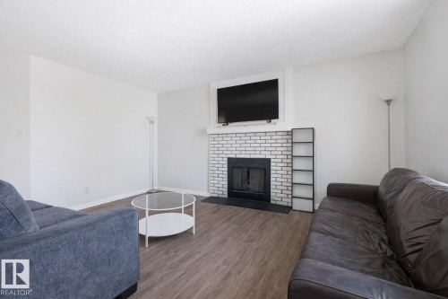 #302 6204 180 St Nw, Edmonton, AB - Indoor Photo Showing Living Room With Fireplace