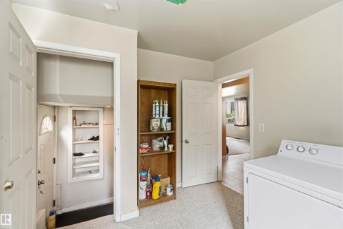 Laundry area with light-toned walls and speckled carpeting - 12243 104 Street Nw, Edmonton, AB - Indoor Photo Showing Laundry Room
