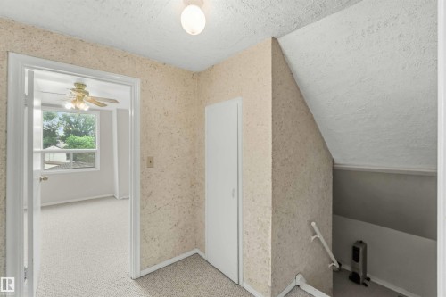 Upper-level landing featuring textured wall finish and a flush-mount ceiling light - 12243 104 Street Nw, Edmonton, AB - Indoor Photo Showing Other Room