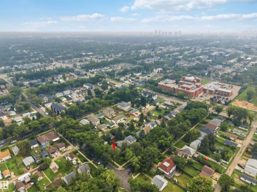 Aerial perspective showcasing the residential neighborhood with dense tree coverage and established streets - 12243 104 Street Nw, Edmonton, AB - Outdoor With View